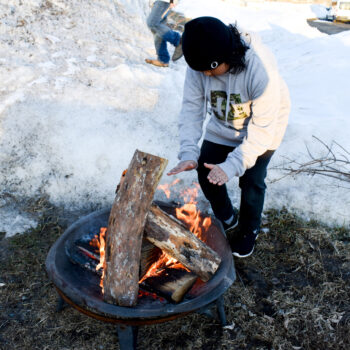 kid getting warm by the fire